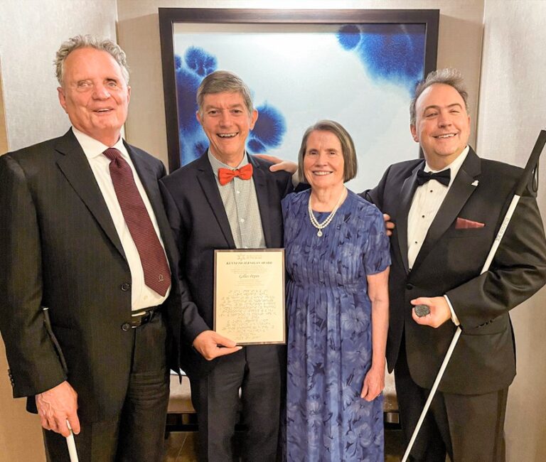 Group photo captured at the 2023 NFB National Convention, featuring Gilles Pepin proudly holding his well-deserved award joined by Dr. Marc Maurer, past NFB President, Mary Ellen Jernigan, the wife of the late Kenneth Jernigan, and Mark Riccobono, the current President of the NFB.