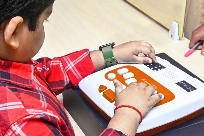 Image of a side view of the Annie device with a student using the standard keyboard.