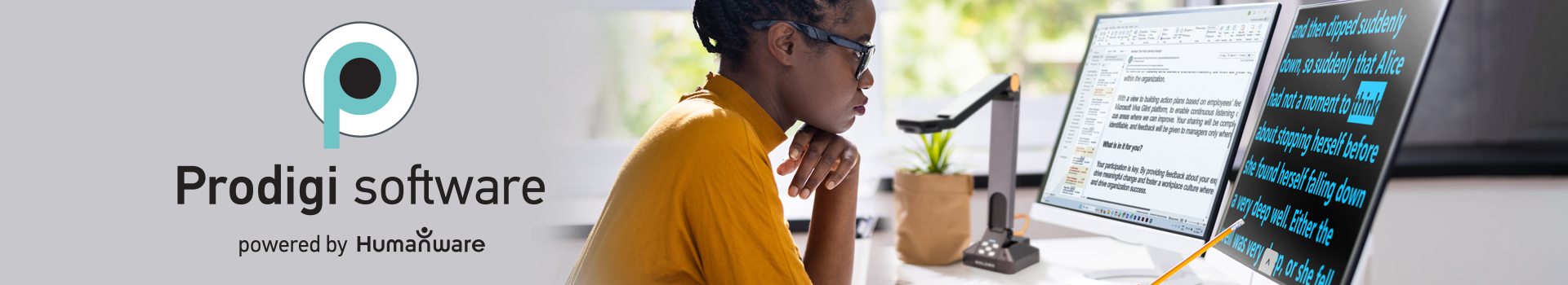 Image of a professional wearing glasses looks at a computer screen displaying blue text on a black background.