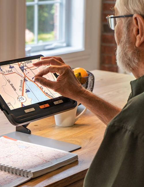 Image showing the finger pinch movement to demonstrate image enlargement of a map on the exploré 12 touch screen.