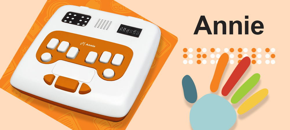 Annie, a white and orange device with various buttons and interfaces for learning braille. Next to it, a colorful hand on braille. 