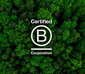 A green forest with the "Certified B Corporation" logo, symbolizing sustainability and social responsibility.